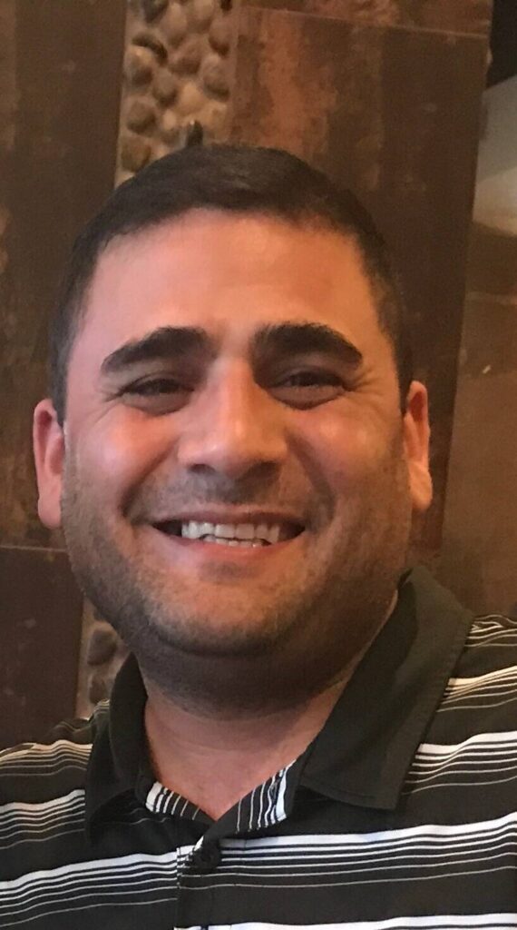 Smiling man in a striped polo shirt, representing positive experiences with VIP Staffing in a success story context.